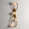 Artorius Wall Sconce in White Quartz with Vintage Gold finish on a neutral background.