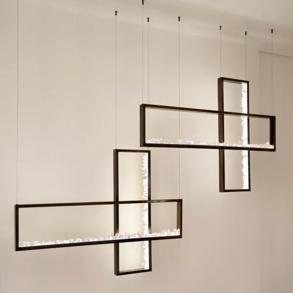 Quartz pendant trios in dark silver leaf in an art gallery with white walls.