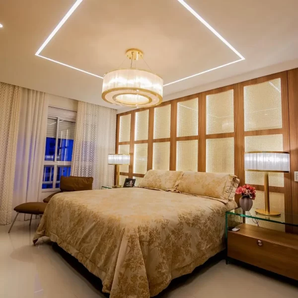 Master suite bedroom featuring two natural Stone Dubai table lights and a chandelier with adjustable cables.