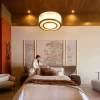 Dubai Selenite Lighting fixture in a luxury bedroom with Warm Gold Leaf finish.