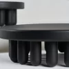 Par of Small black-painted wooden centerpiece and white background.