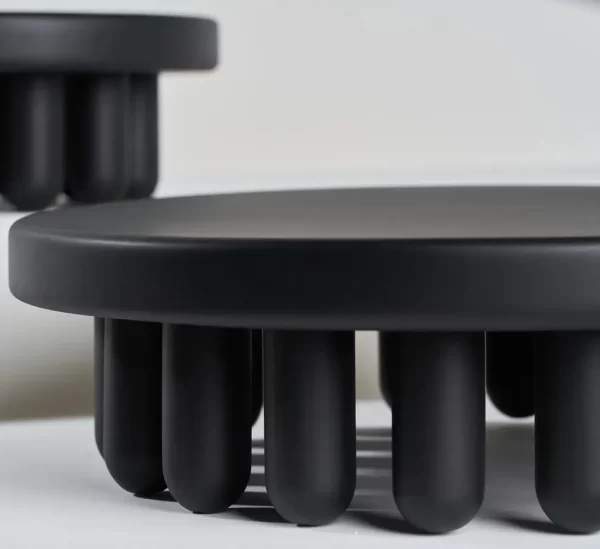 Par of Small black-painted wooden centerpiece and white background.