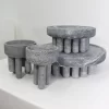 Set of four soapstone pieces, including small and large bowls and centerpieces, on a white background.