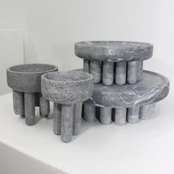 Set of four soapstone pieces, including small and large bowls and centerpieces, on a white background.