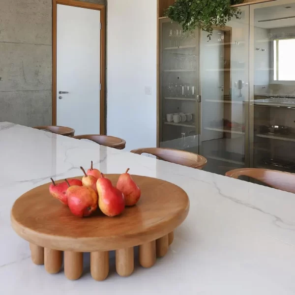 Large centerpiece with red pears on a dining table.