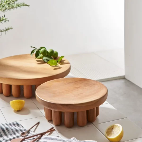 Pair of small and large Embrace Centerpieces adorned with lemons and rosemary in a kitchen environment.