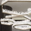 Custom Set of Four Selenite LED Chandeliers San Francisco in Antique Bronze, Creating a Ceiling Art Piece Against Dark Rounded Walls.
