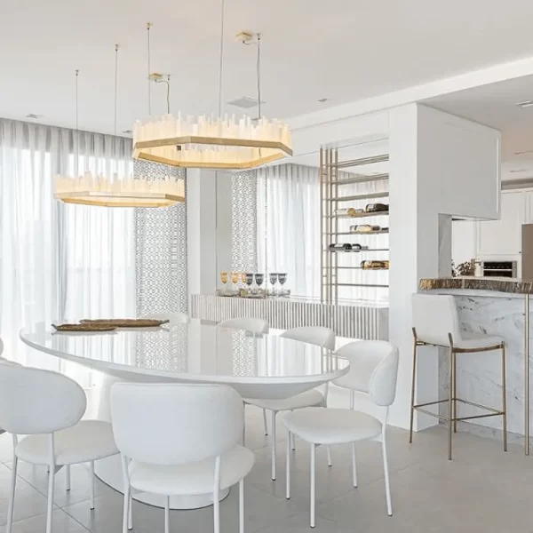 Luxurious pair of modern natural stone LED pendants illuminating a spacious neutral-toned open concept dining area.