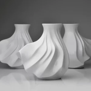Three of matte white porcelain vases on a white background.
