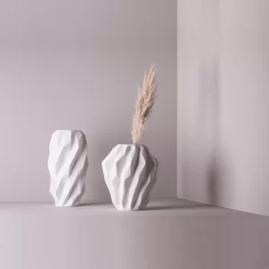 Studio composition with a pair of matte white Plisan Geometric Vases.