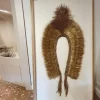 Canvas background of the Headdress, Indigenous Natural Fiber, Antunes, shown in a neutral setting.