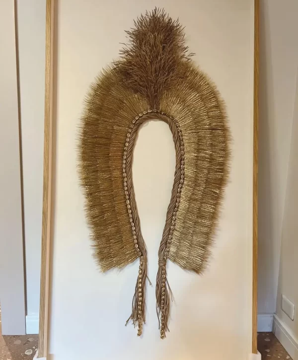 Close-up of the Freijó-colored frame of the Headdress, Indigenous Natural Fiber, Antunes, against a neutral background
