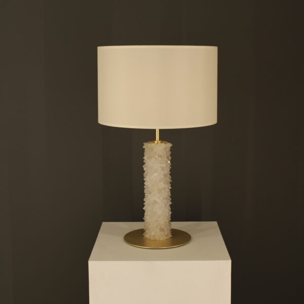 Hong Kong Quartz Table Lamp with gold leaf finish on white pedestal against black background