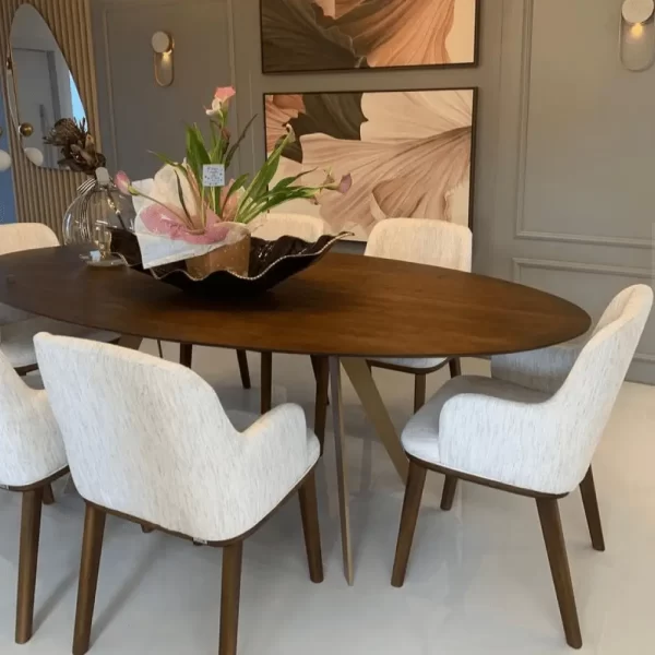 Handcrafted fused art glass with black finish and gold edge on elegant dining table adorned with flowers.