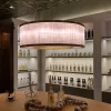 Dubai Cylindrical Natural Stone Chandelier with Dark Silver Leaf finish in a luxury retail setting.