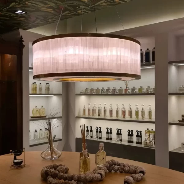 Dubai Cylindrical Natural Stone Chandelier with Dark Silver Leaf finish in a luxury retail setting.