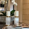 A pair of Candle Holders, Natural Stone, Alexxa III, featuring exquisite craftsmanship in selenite with a warm gold leaf finish, displayed in the Haus of Aurah showroom.