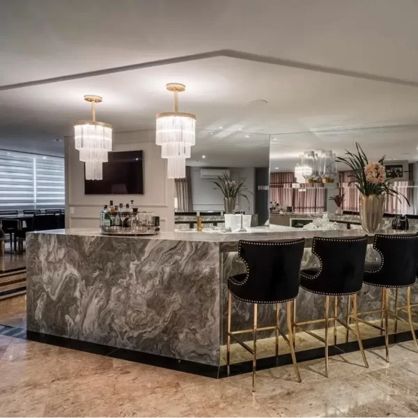 Distant view of an American kitchen with a Petit London Natural Stone Lighting Fixture above a central island.