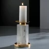 Studio image of the Alexxa III Natural Stone Candle Holder in gold leaf with a lit candle, emphasizing its intricate selenite detailing.