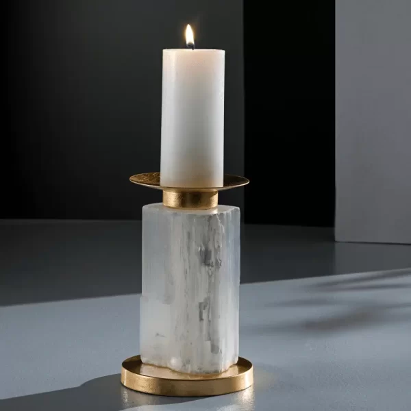 Studio image of the Alexxa III Natural Stone Candle Holder in gold leaf with a lit candle, emphasizing its intricate selenite detailing.
