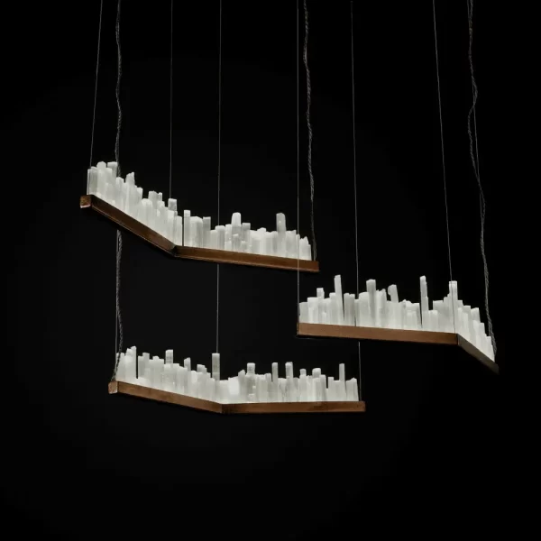 Artistic Display of Three Selenite LED Pendant Lights Lisbon in Dark Silver Leaf Finish, Set Against a Black Background