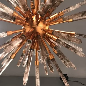 Image of a sophisticated studio featuring a Barcelona chandelier with Warm Gold Leaf finish and Smoked Quartz, radiating warm and elegant light.