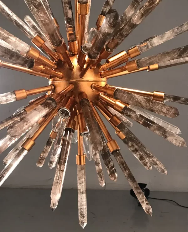 Image of a sophisticated studio featuring a Barcelona chandelier with Warm Gold Leaf finish and Smoked Quartz, radiating warm and elegant light.