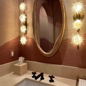 Two genuine Quartz Wall Sconces shining in a bathroom.