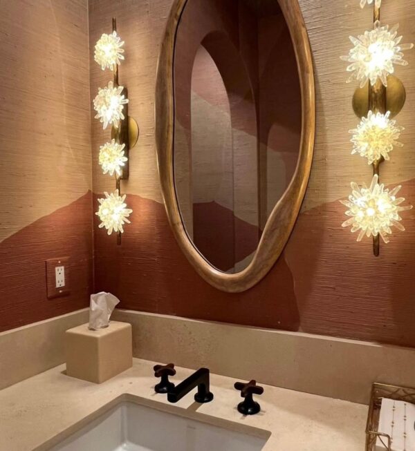 Two genuine Quartz Wall Sconces shining in a bathroom.