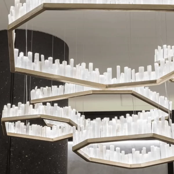 Custom Set of Four Selenite LED Chandeliers San Francisco in Antique Bronze, Creating a Ceiling Art Piece Against Dark Rounded Walls.