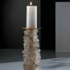 Desiree V White Quartz Candle Holder in a sophisticated setting, illuminated by a burning candle, showcasing its radiant beauty and practical elegance.
