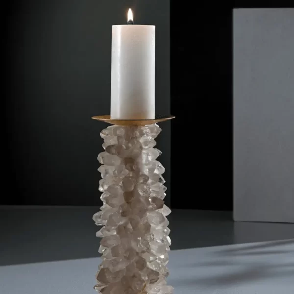 Desiree V White Quartz Candle Holder in a sophisticated setting, illuminated by a burning candle, showcasing its radiant beauty and practical elegance.