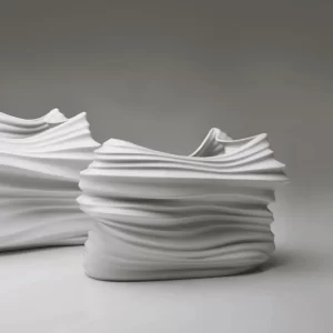 Details of the pair of matte white porcelain vases on a white background.