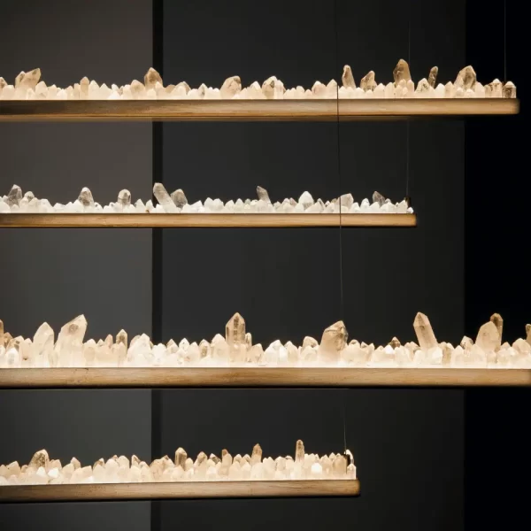 Set of 4 Quartz Pendant LED Lamps New York 36″ in Antique Bronze, Illuminated with White Quartz, Studio Setting on Black Background.