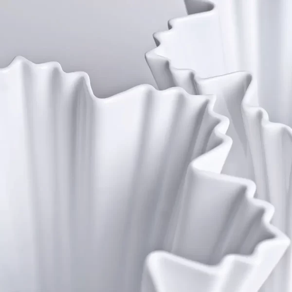 Pair of ICE I Fine Porcelain Vases in matte white on a white background.