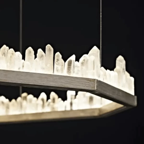 Close-up of Haus of Aurah's Quartz LED Chandelier revealing exquisite craftsmanship, black background.