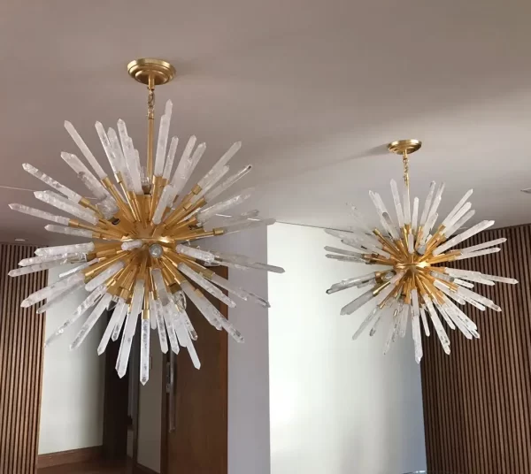 Image of an apartment interior featuring a pair of Barcelona chandeliers with Gold Leaf finish and White Quartz, adding a touch of luxury and sophistication to the space.