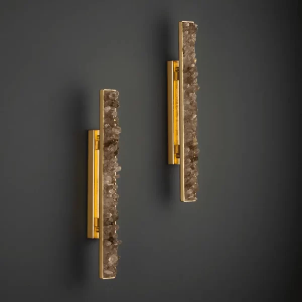 Pair of Quartz LED Wall Lamps New York 24″ with smoked quartz and warm gold leaf finish, installed side by side on a dark wall, creating an elegant ambiance.