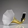 Gold Porcelain Gramophone Speaker with a smartphone inserted, demonstrating its functionality on a white background.