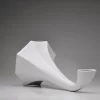 Matte white porcelain gramophone speaker with a focus on the speaker horn on a white background.