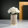 Front view of a Quartz Flower Pot adorned with white petals, highlighting its elegant design and warm gold leaf finish.