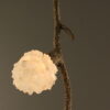 Close-up detail of the Quartz Cascade Pendant - Branches IX showing a glowing cluster of quartz crystal lights on the bronze twig-like frame.