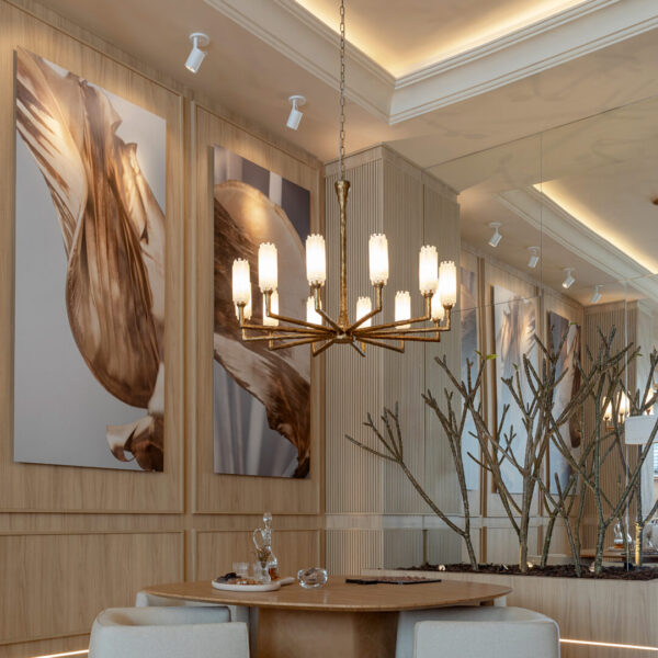Vintage ceramic chandelier hanging over a lround dining table in a spacious room, front viewed.