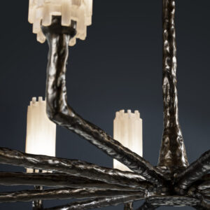 Details of a modern circular selenite chandelier with rustic ceramic finish against a black background.