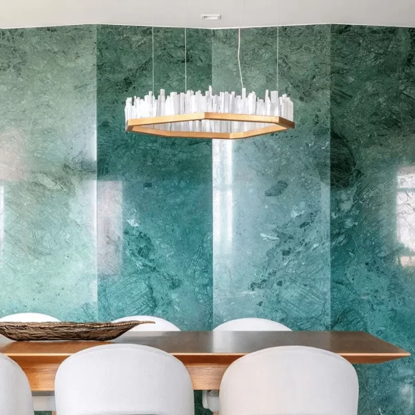 Selenite LED Chandelier San Francisco in Warm Gold Leaf Finish, Highlighting a Dining Area with Blue Granite Wall.