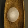 Wall light with a golden textured base and a translucent spherical crystal, combining raw materials with refined craftsmanship.