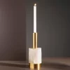 Studio image of the Alexxa II Natural Stone Candle Holder in gold leaf with a brass base, featuring a lit candle and handcrafted selenite detailing.