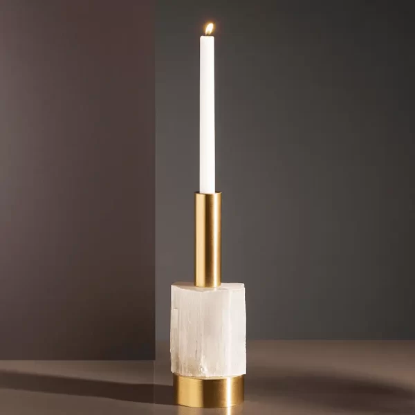Studio image of the Alexxa II Natural Stone Candle Holder in gold leaf with a brass base, featuring a lit candle and handcrafted selenite detailing.