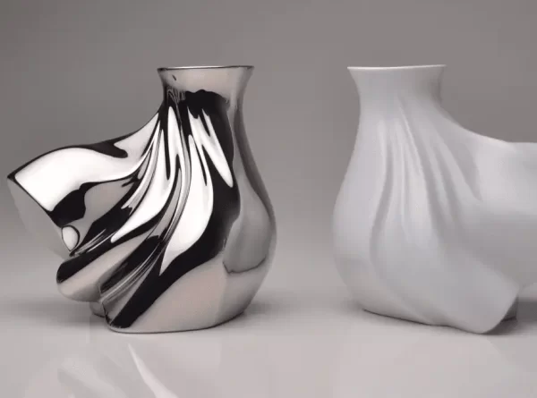 Pair of porcelain vases, one in silver and one in matte white, on a white background.