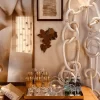 Wooden, Cotton Chain Link Wall Decor with Boho Chic Details in Illuminated Room